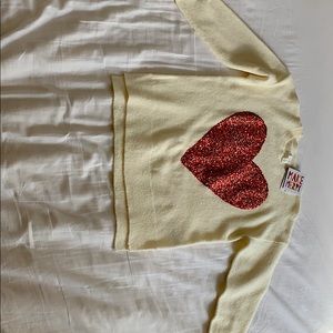 It is a very soft cardigan with a big red heart.